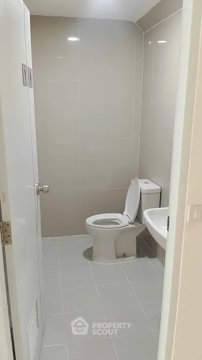 Modern bathroom with sleek tiles and compact design