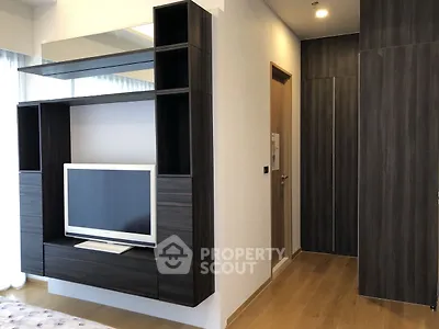 Modern living room with sleek TV unit and wooden flooring