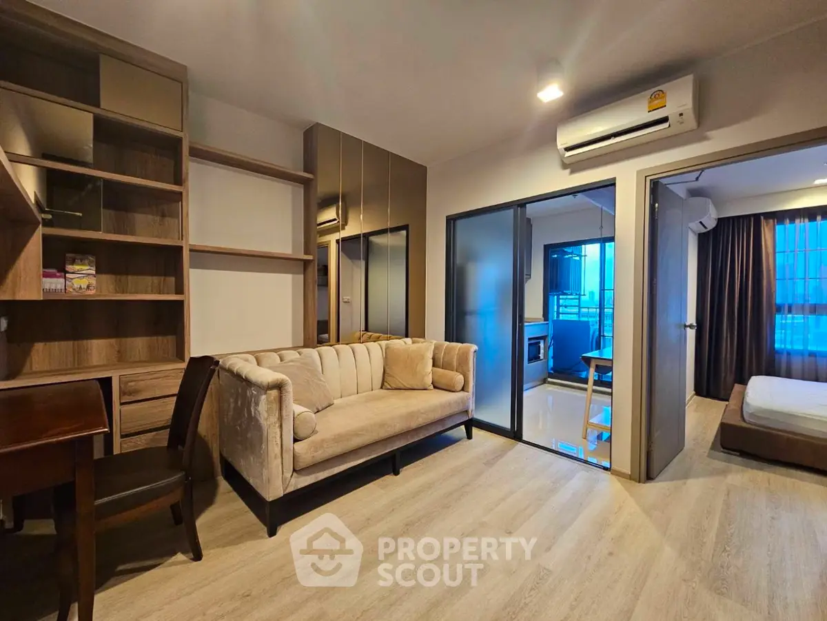 Modern apartment interior with cozy living room and bedroom, featuring stylish furniture and wooden flooring.