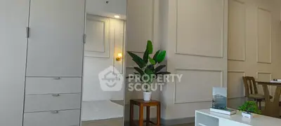 Modern living room with elegant decor and indoor plant, showcasing stylish furniture and ambient lighting.