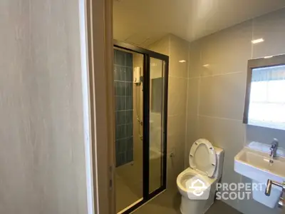 Modern bathroom with sleek shower and contemporary fixtures in a stylish apartment.