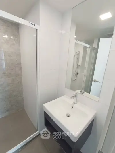 Modern bathroom with sleek sink and glass shower enclosure