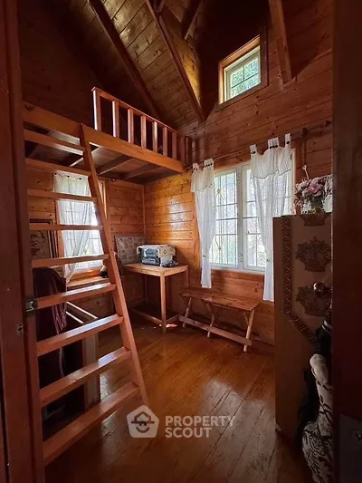 Charming wooden cabin interior with loft and natural light