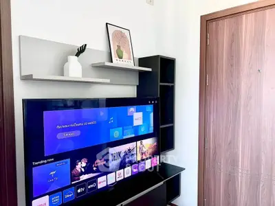 Modern living room with smart TV and stylish shelving, perfect for entertainment and relaxation.