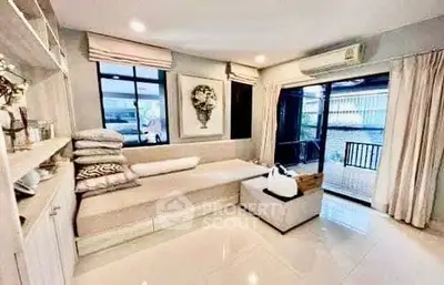 Spacious living room with modern decor and large windows for natural light.