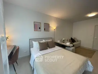 Modern bedroom with stylish decor and cozy seating area, perfect for relaxation.