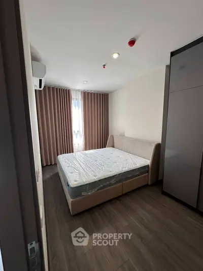 Modern bedroom with sleek design, featuring a comfortable bed and stylish wardrobe, perfect for urban living.