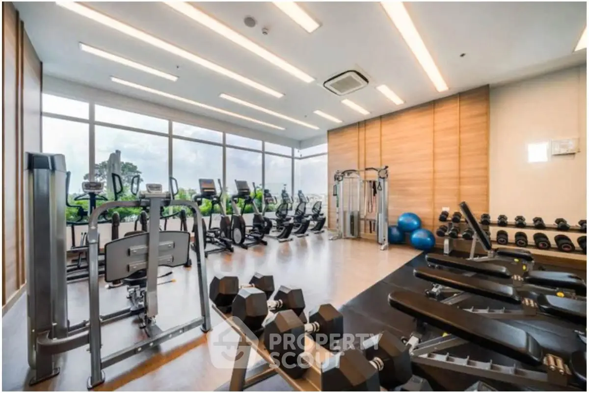 Modern gym with state-of-the-art equipment and large windows offering scenic views.