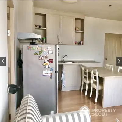 Cozy kitchen with dining area and modern appliances in a stylish apartment