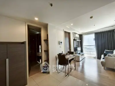 Modern living room with sleek furniture and balcony access in a stylish apartment.