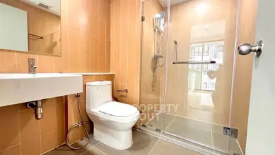 Modern bathroom with glass shower and sleek fixtures in a contemporary apartment.