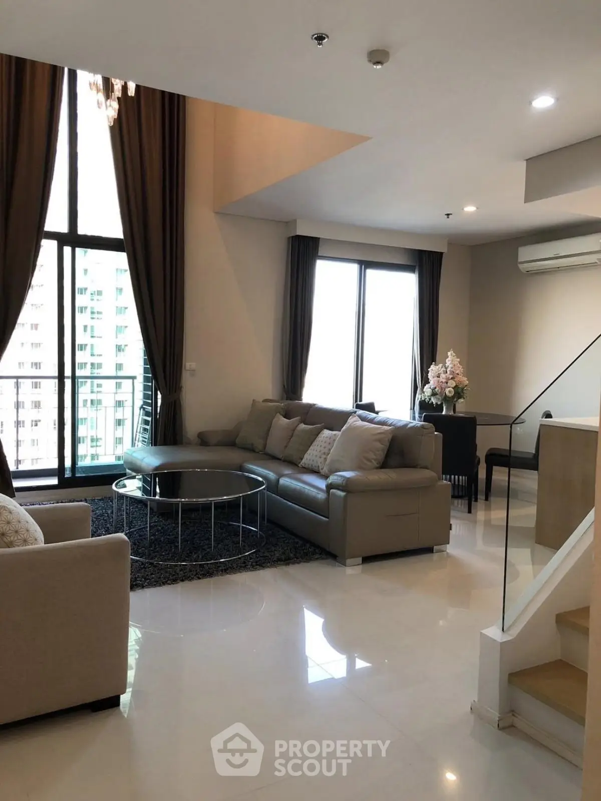 Spacious modern living room with high ceilings and elegant decor