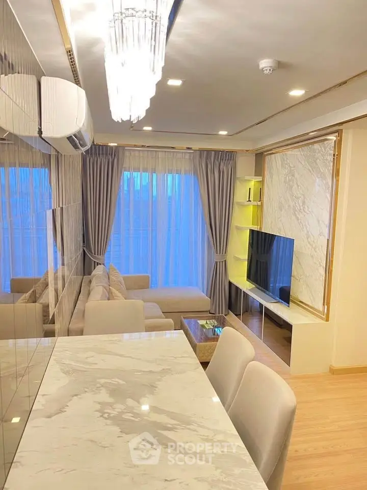 Luxurious modern living room with elegant marble dining table and cozy seating area, perfect for relaxation.