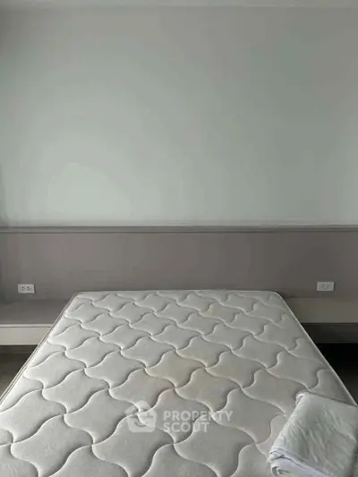 Spacious bedroom with a large bed and minimalist design, perfect for relaxation and comfort.