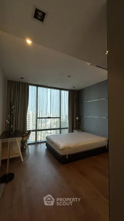 Spacious bedroom with city view and modern furnishings