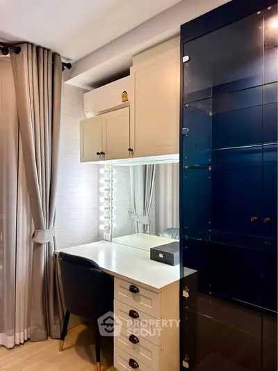Stylish study nook with elegant cabinetry and modern lighting in a cozy apartment.
