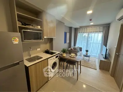Modern open-layout kitchen and living room with stylish decor and natural light.