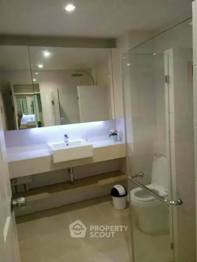 Modern bathroom with glass shower and sleek fixtures