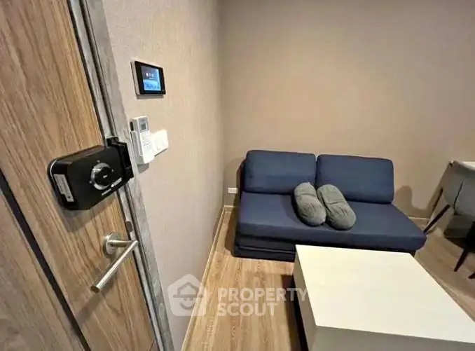 Cozy living room with modern sofa and smart lock entry, perfect for urban living.