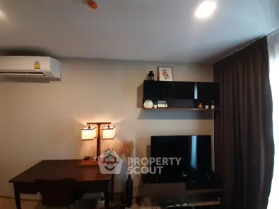 Modern living room with stylish decor, wall-mounted TV, and elegant lighting.