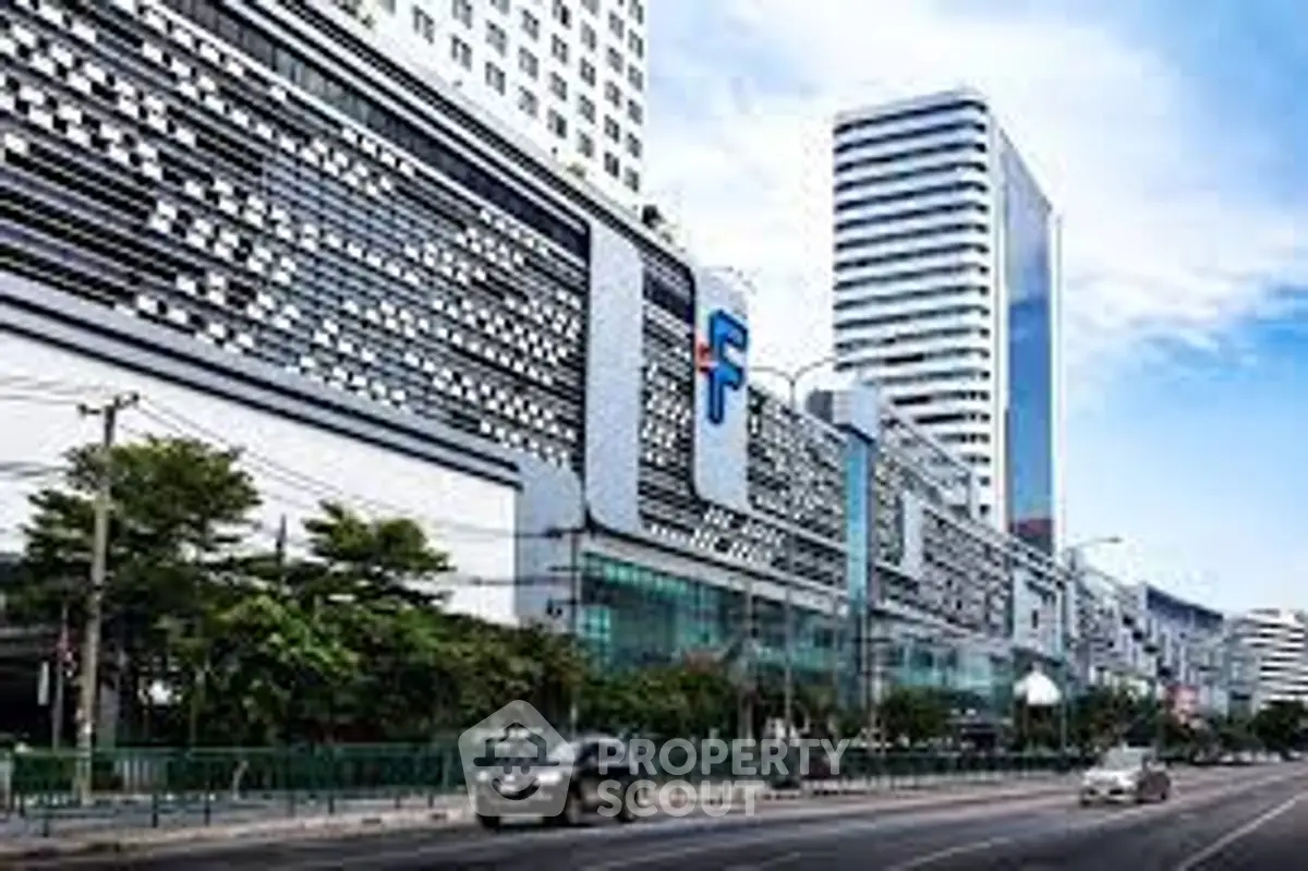 Modern commercial building with unique facade design and urban street view.