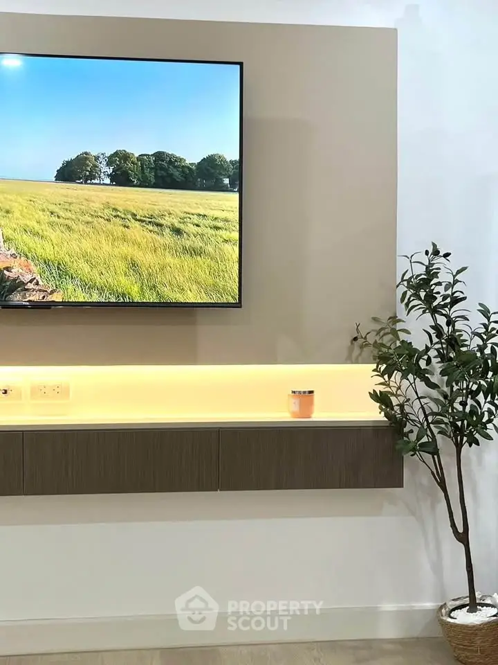 Modern living room with wall-mounted TV and sleek floating shelf