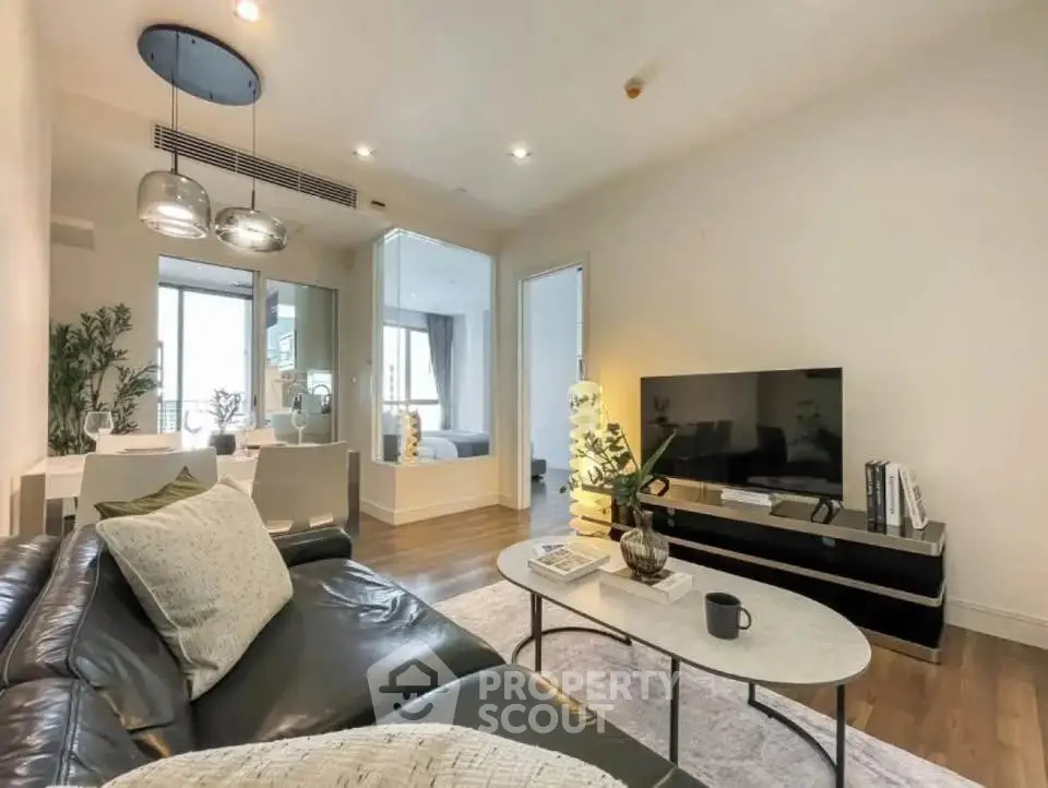 Modern living room with sleek furniture and open dining area, perfect for urban living.