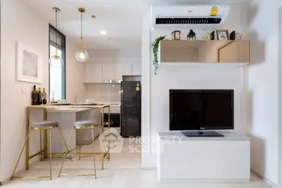 Modern open-plan kitchen and living area with stylish decor and sleek appliances.