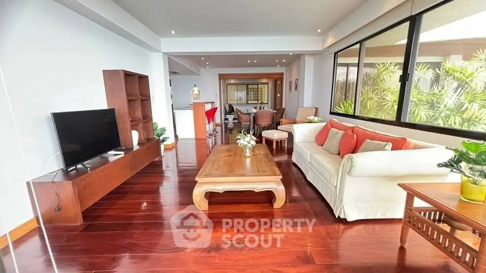 Spacious living room with elegant wooden flooring and modern furniture