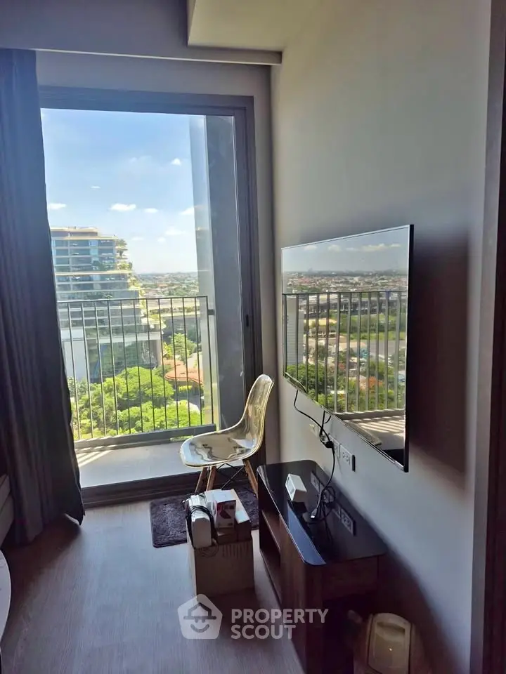 Modern apartment with stunning city view from balcony, featuring sleek wall-mounted TV and stylish decor.