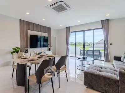 Modern living room with dining area and large windows offering scenic views.