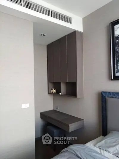 Modern bedroom with built-in study nook and sleek cabinetry