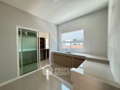 Modern kitchen with sleek cabinetry and ample natural light