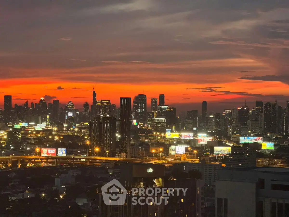 Stunning city skyline view at sunset with vibrant colors and illuminated buildings.