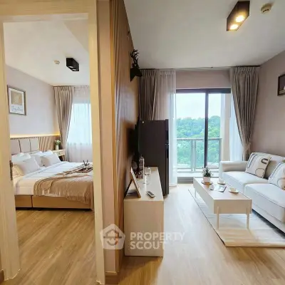 Modern apartment with cozy living room and stylish bedroom, featuring large windows and natural light.
