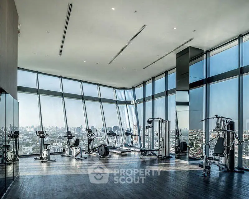 Luxurious high-rise gym with panoramic city views and modern fitness equipment.