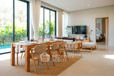 Luxurious open-plan living room with pool view and elegant dining area