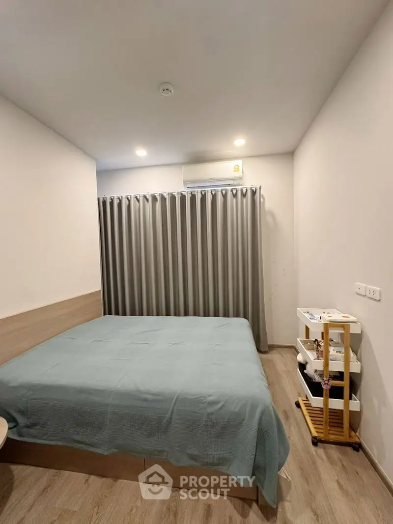 Cozy bedroom with modern decor and soft lighting, featuring a comfortable bed and stylish curtains.