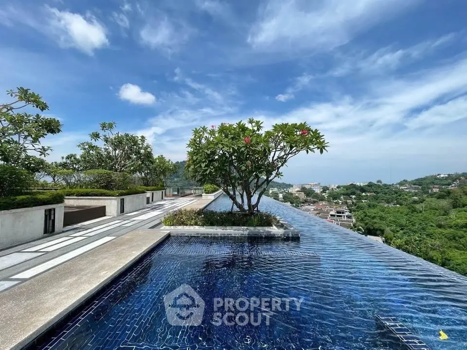 Luxurious rooftop infinity pool with stunning panoramic views and lush greenery.