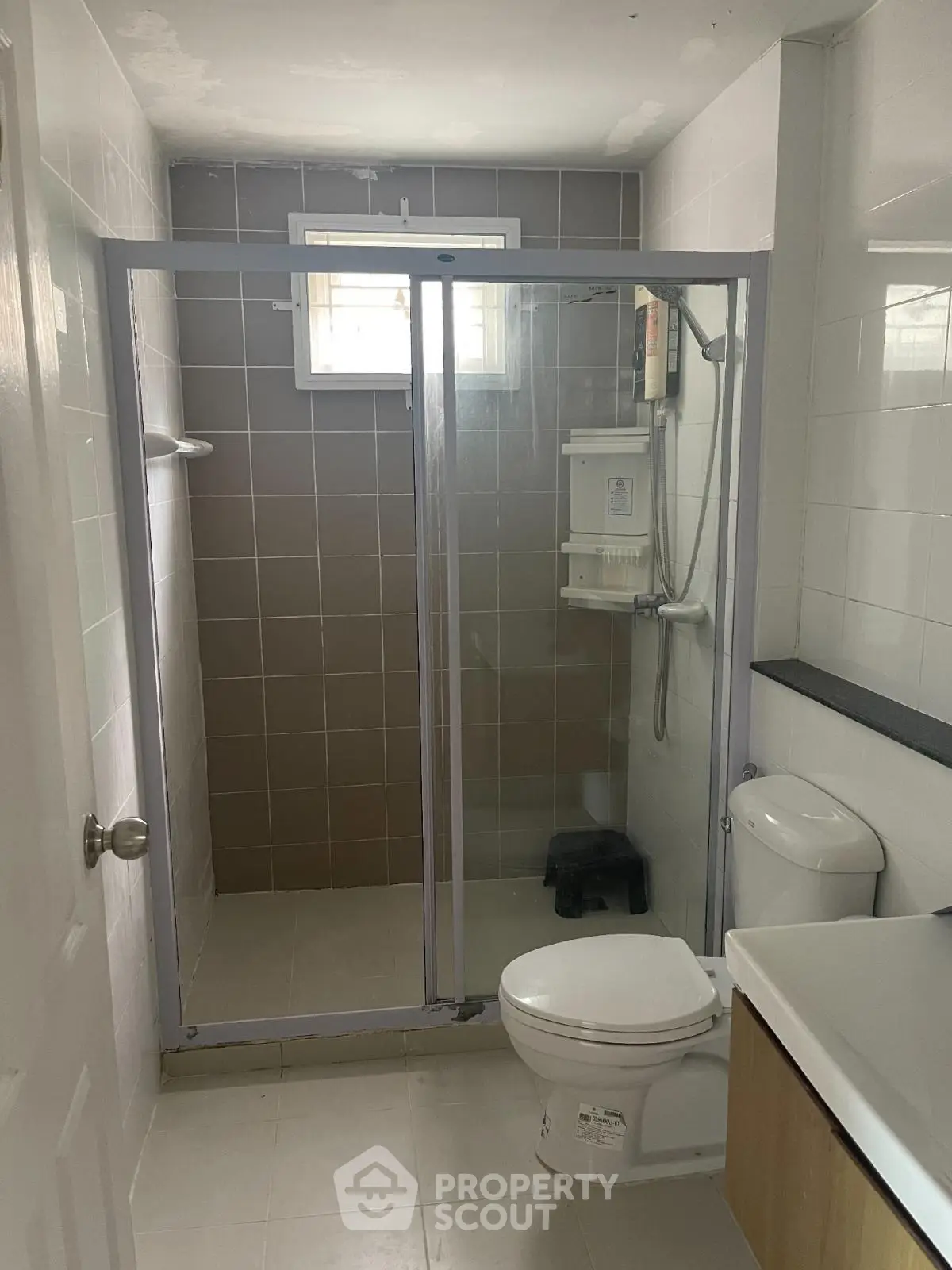 Modern bathroom with glass shower enclosure and sleek fixtures