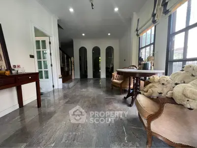 Spacious living room with elegant furniture and large windows offering natural light