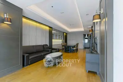 Spacious modern living room with elegant lighting and hardwood floors