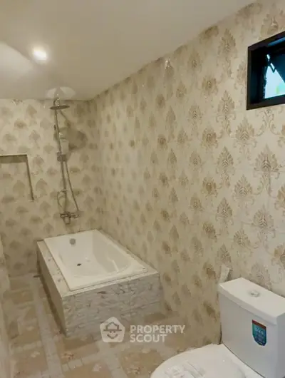 Spacious bathroom with elegant tile design and built-in bathtub