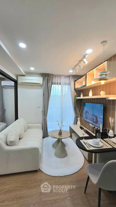 Modern living room with stylish decor, cozy sofa, and elegant dining setup in a bright, airy space.