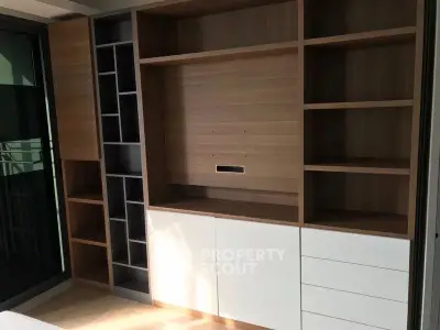 Modern built-in wooden shelving unit with sleek design in a bright room.