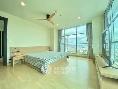 Spacious bedroom with panoramic city view and modern furnishings