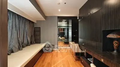 Luxurious modern living room with elegant wood flooring and stylish decor.