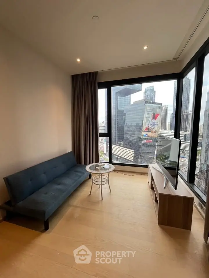 Modern living room with stunning city view, featuring a sleek sofa and flat-screen TV, perfect for urban living.