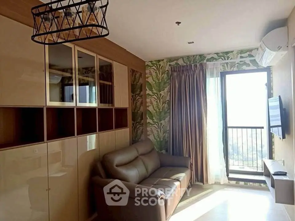 Stylish living room with modern decor and balcony view, featuring a cozy sofa and elegant storage cabinets.