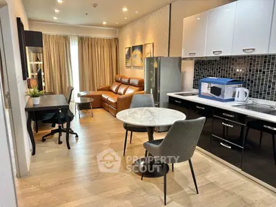 Modern open-plan living room with stylish furniture and kitchen area, perfect for urban living.